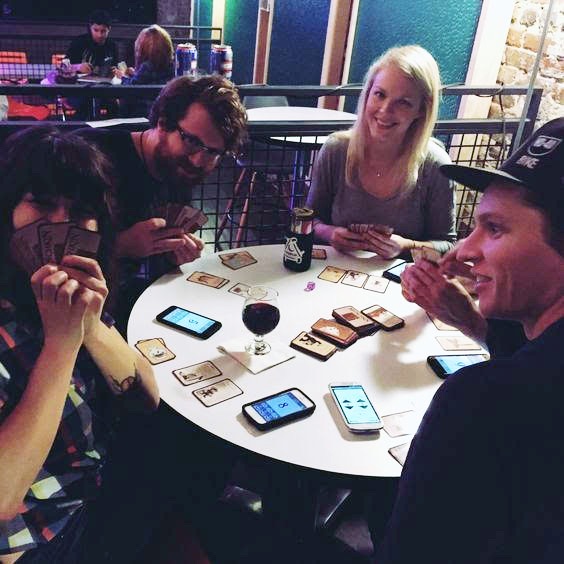 Friends playing a card game at Saturn