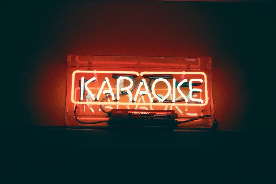 The neon KARAOKE sign in the karaoke room at Saturn